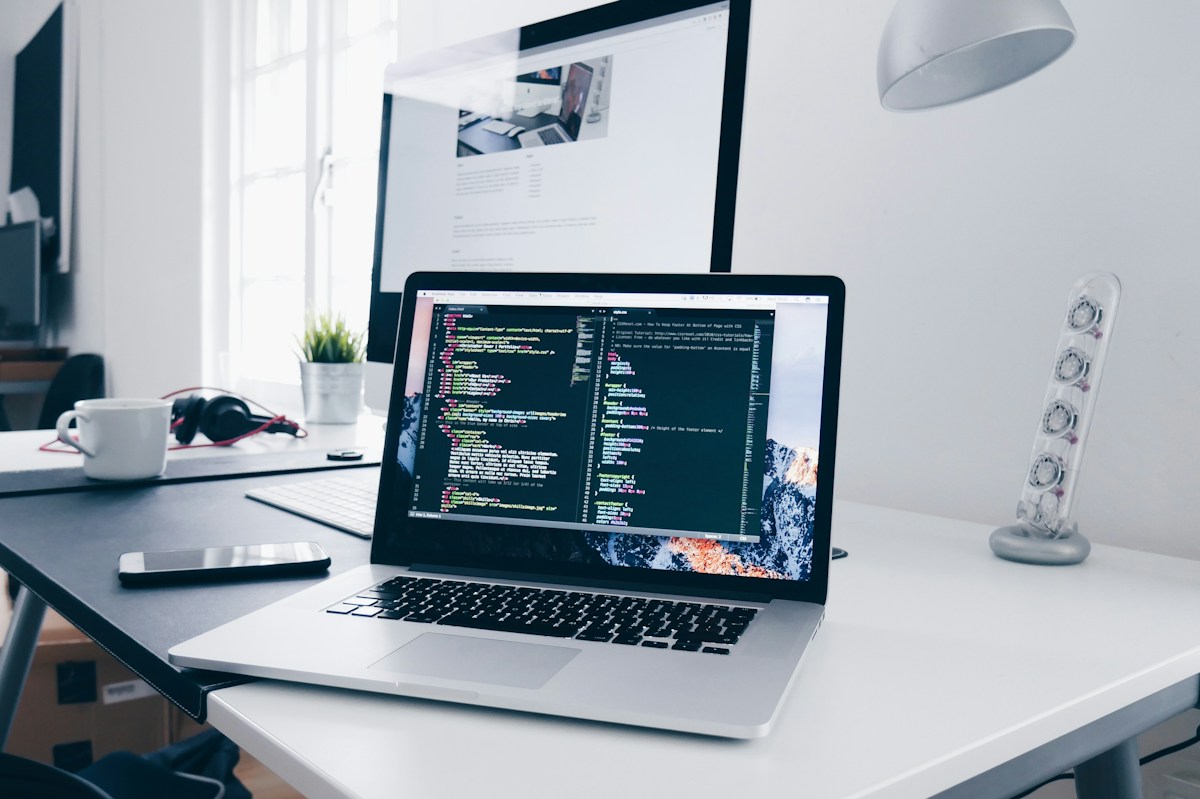 A workspace with a computer and coding monitor